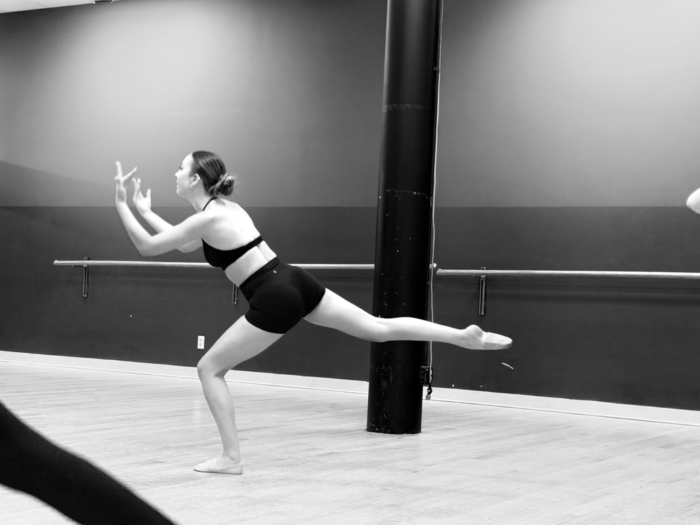 A dancer in arabesque at the barre